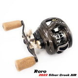 Eine Nahaufnahme einer Baitcasting-Angelrolle mit Korkgriffen und metallisch-schwarzem Finish. Der Text unten lautet „Roro Lure 22 Silver Creek Air“ und verfügt über eine BFS Titanium Spule AX22 für präzise Wurfweiten.